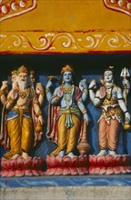 INDIA, Orissa, Gopalpur on Sea, Detail of colourful temple carvings depicting Hindu Gods