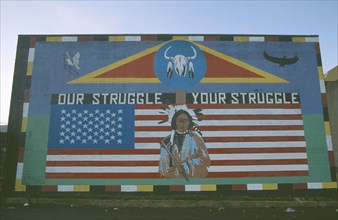 IRELAND,  North , Belfast, "Red Indian mural depicting traditional indian figure standing against