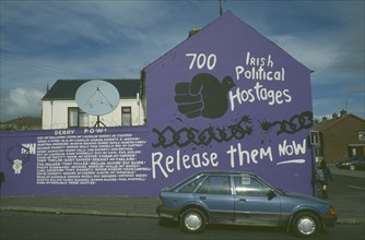 IRELAND,  North  , Derry, Mural listing the names of Irish Political Hostages in the Bogside area.