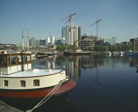 ENGLAND, London, "Docklands waterfront building development, moored boats "