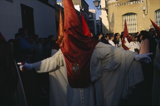 SPAIN, Andalucia, Seville, Semana Santa  Easter procession with hooded Penitent
