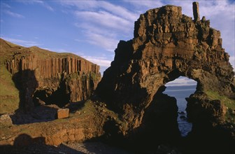 SCOTLAND, Isle of Mull, View through Carsaig arches formed from basalt rock and coastline