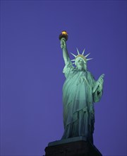 USA, New York City, New York, Angled view looking up at the Statue of Liberty at night