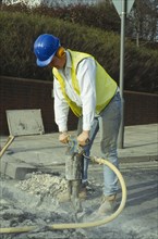 ARCHITECTURE, Construction, Workers, Man wearing ear protection helmet and goggles using pneumatic