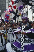 ENGLAND, London, "Notting Hill Carnival dancers in black, white and purple costumes"