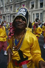 ENGLAND, London, Notting Hill Carnival man dressed as a pirate with yellow shirt and skull and