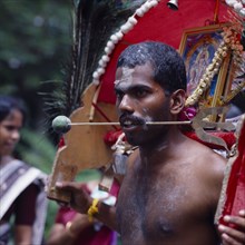 SINGAPORE, Religion, "Male devotee Tahipausam Hindu festival,needles pierce tongue/cheek "