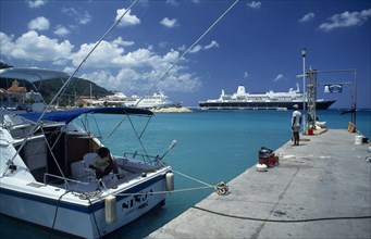 WEST INDIES, Jamaica, Ocho Rios, Harbour view with man standing on stone jetty and cruise ships