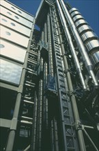 ENGLAND, London, View looking up at the lifts on the exterior of the Lloyds building