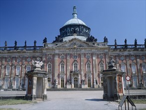 GERMANY, Potsdam, Sanssouci, The New Palace facade and dome seen through the entrance gates