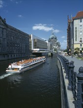 GERMANY, Berlin, View of boat travelling down the river Spree toward the Parliament building and