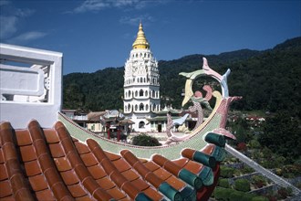 MALAYSIA, Penang, Kek Lok Si Temple, View over rooftop detail toward white tower with golden roof