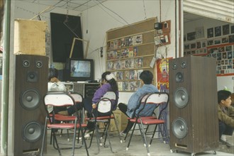 CHINA, Children, Television, Youths watching television in shop.