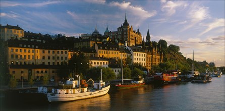 SWEDEN, Stockholm, Evening shot of the waterfront area with boats moored