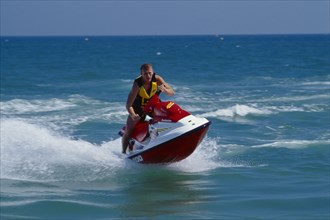 20001992 SPORT Water Sports Jet Ski Person on a red jet ski in action
