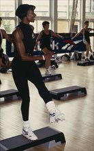 10001952 SPORT Excercise Gym A young black woman taking part in a step workout