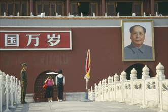CHINA, Hebei, Beijing, Policeman under picture of Chairman Mao