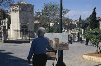 GREECE,  , Athens, Temple of the Winds with artist standing at easel painting in the square