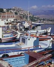 GREECE, North Eastern Aegean, Lesvos, Mytilini with a view over fishing boats in the foreground