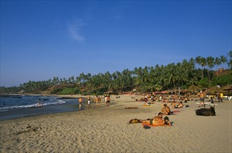 INDIA, Goa, Little Vagator Beach, "View along beach, people sunbathing and beach bar on right "
