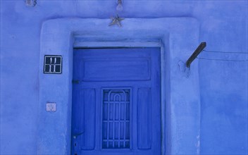 EGYPT, Eastern Desert, Hurghada, Detail of blue painted house and entrance with a starfish above a