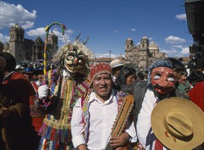 PERU, Cusco Department, Cusco, "Group of musicians and masked dancers in traditional costume at