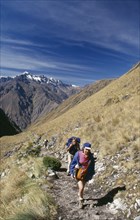 PERU, Cusco Department, The Inca Trail, Treckers with back packs walking up Dead Woman´s Pass.