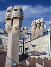 SPAIN, Catalonia, Barcelona, "La Pedrera.  Gaudi architecture, carved chimney pots on the rooftop."