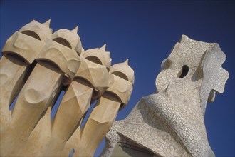 SPAIN, Catalonia, Barcelona, La Pedrera apartments designed by Gaudi with angled view of chimney