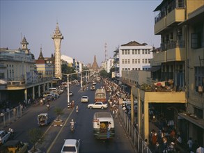 MYANMAR, Yangon, "View over busy pavements, city architecture and wide, central road. "