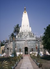MYANMAR, Yangon, "Buddhist temple exterior with the sun reflecting off the silver spire, view along