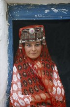 CHINA, Tienshan, Tashgurgen, Tajik girl in traditional costume at house on the Silk Route
