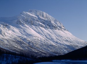 NORWAY, Troms, Lavangsdalen, Snow covered mountainside.