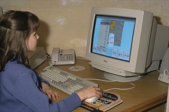 COMPUTER, School, Young girl using educational software on a home computer.