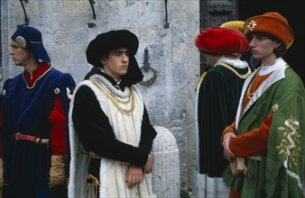 ITALY, Tuscany, Sienna, Group of young men in medieval costume in the Piazza del Campo.
