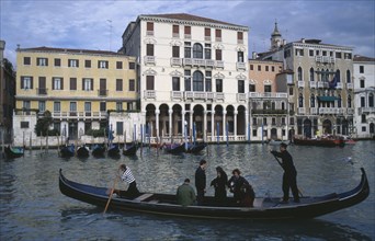 ITALY, Veneto, Venice, A Traghetti gondola taxi with passengers on the Grand Canal.