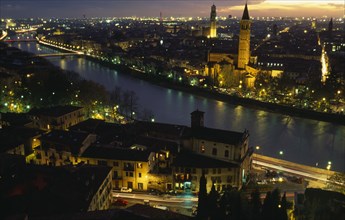ITALY, Veneto, Verona, View over the Adige river and city at night.