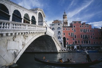 ITALY, Veneto, Venice, "The Rialto bridge and a gondola with passengers, the Rialto Hotel in the