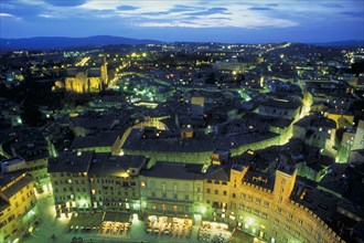ITALY, Tuscany, Sienna, View across Siena at night.  The Piazza del Campo in the foreground.