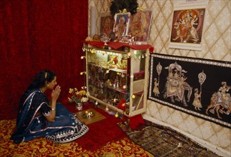 SOCIETY, Religion, Hinduism, England.  Girl at prayer at home during Dirwali.