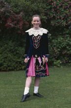 IRELAND, Children, "Young girl in Irish folk costume, standing facing the camera."