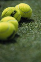 20006837 SPORT Ball Games Tennis Detail of luminous tennis balls on lawn.