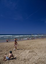 PORTUGAL, Algarve, Praia da Rocha, View along beach with children playing beach soccer