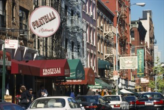 USA, New York State, New York, Mulberry Street in Little Italy lined with cars and restaurants.