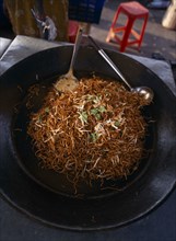 MALAYSIA, Kedah, Langkawi, A wok full of mee goreng a traditional spicey noodle dish on a stall at