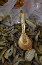 MALAYSIA, Kedah, Langkawi, Spoon in a bowl of green mangoes with vinegar on a stall at the Night