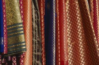 MALAYSIA, Kedah, Langkawi, Silk fabrics hanging outside a shop in Kuah old town
