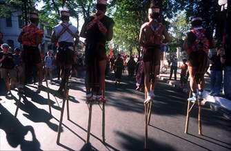 VIETNAM, Ho Chi Minh City, Line of stilt walkers at the 25th Anniversary Parade for the liberation