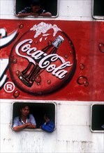 VIETNAM, Mekong Delta, Vinh Long, "Advertisment for Coca Cola on the side of a ferry, passengers at