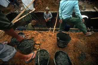 VIETNAM, Ha Bac, Workers laying steel reinforced building foundations.